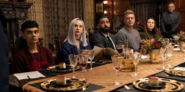 The Usher family sitting at the dinning room table in The Fall of the House of Usher. 