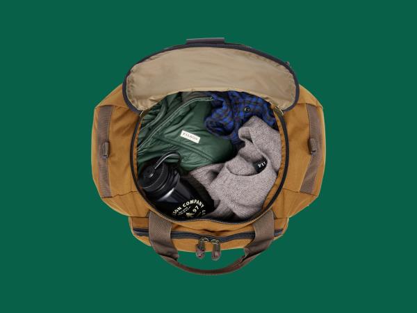 Filson Ballistic Nylon Duffle Pack on green backdrop