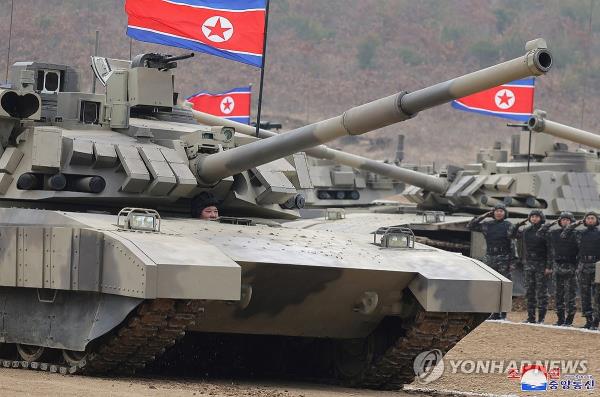 This photo, carried by North Korea's official Korean Central News Agency on March 14, 2024, shows the North's leader Kim Jong-un driving a new battle tank during the 