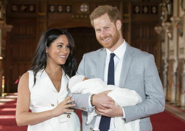 FILE - In this Wednesday May 8, 2019 file photo, Britain's Prince Harry and Meghan, Duchess of Sussex, during a photocall with their newborn son Archie, in St George's Hall at Windsor Castle, Windsor, south England.  In a stunning declaration, Britain’s Prince Harry and his wife, Meghan, said they are planning 