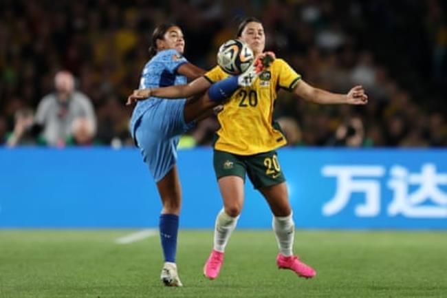 Jess Carter kicks the ball right in front of Sam Kerr’s chest