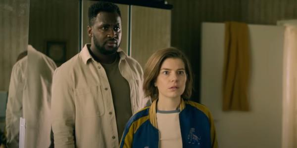 Aimee-Ffion Edwards and Kadiff Kirwan look at something off-camera in Slow Horses season 3.