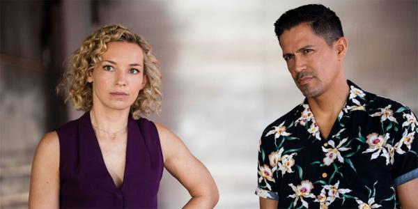 Jay Hernandez and Perdita Weeks standing together in Magnum PI