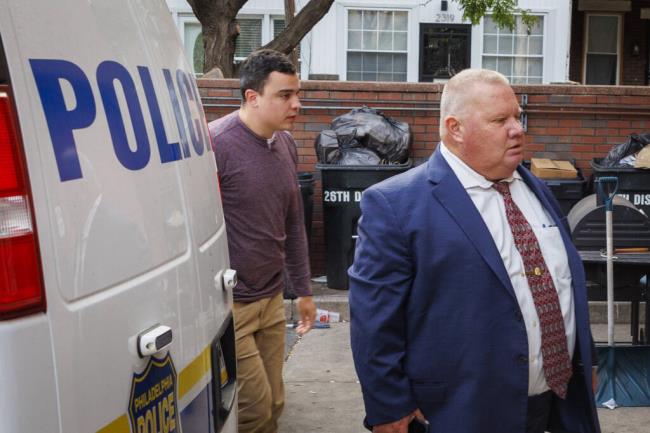 Philadelphia Police officer Mark Dial, left, enters the 1st District Police station in Philadelphia, Friday, Sept. 8, 2023. Dial fatally shot Eddie Irizarry during a traffic stop on Aug. 14. (Alejandro A. Alvarez/The Philadelphia Inquirer via AP)