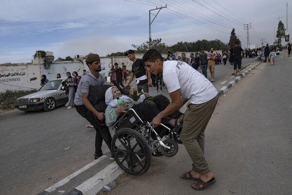 Palestinians flee to the southern Gaza Strip on Salah al-Din Street in Bureij. Picture: AP Photo/Fatima Shbair